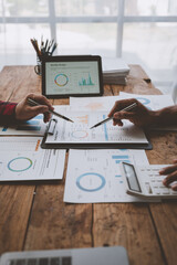 Wall Mural - Team work process, business team using calculator to calculate figures of business statistics, profit, growth rate graph document. information charts on the office desk.