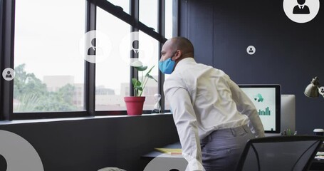 Poster - Animation of profile icons floating over biracial man in face mask looking out of window at office