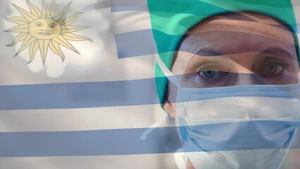 Poster - Animation of waving uruguay flag against caucasian female surgeon in surgical mask at hospital