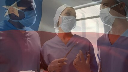 Canvas Print - Animation of waving texas flag against team of diverse surgeons discussing together at hospital