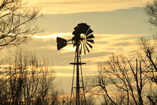 windmill silhouette at sunset with clouds