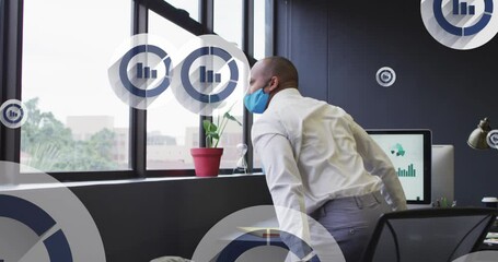 Poster - Animation of bar graph icons floating over biracial man in face mask looking out of window at office