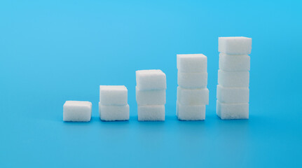 Wall Mural - Sugar cubes chart on blue background