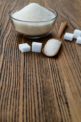 Wall Mural - A bowl granulated sugar and sugar cubes on the table