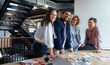 © Jacob Lund - Advertising professionals smiling in a meeting. Business people brainstorming in an office