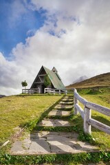 Poster - Rural house on a hill in Dolomites on a cloudy morning