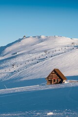 Poster - Small wooden building on a snowy slope