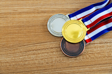 Wall Mural - Three medals on wooden table