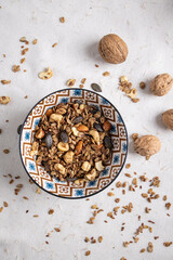 Wall Mural - Top view of a  plate of granola and walnuts on a table