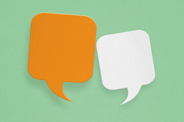 Conceptual image about communication and social media, customer feedback, orange and white speech bubble  grunge paper cut on grunge green background