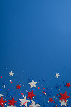 Vertical View From The Top Featuring Patriotic Party Supplies.Glitter Stars, And Sparkle Confetti On A Blue Backdrop With A Space For Text Or Advertising