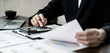 © Orathai - The businessman hand sits at their desks and calculates financial graphs showing the results of their investments planning the process of successful business growth