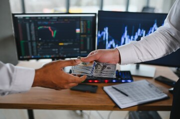 Hand shake between businessman on Trading graph on the cityscape at night and world map background,Business financial concept