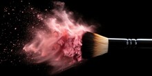 Brush with powder. Make up brush with colorful powder explosion on black background