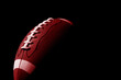 © Augustas Cetkauskas - Red American football ball close up on black background. Horizontal sport theme poster, greeting cards, headers, website and app