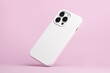 © iso100production - iPhone 14 Pro max starlight in white soft silicone case falls down back view, phone cover mockup isolated on pink background