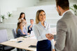 © BGStock72 - Young business woman handshaking with his colleague in the office