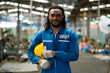 © KANGWANS - Portrait of a professional heavy industrial engineer, African American. Industrial plant background. Industry concept. industrial plant.