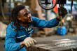 © KANGWANS - Portrait American male worker working with industrial machines in heavy industry. American engineer working on steel machine.