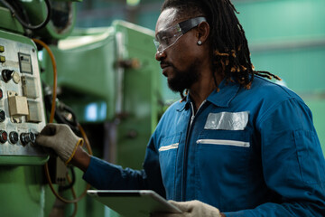 Wall Mural - Portrait American male worker working with industrial machines in heavy industry. American engineer working on steel machine.