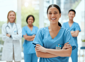 Aufkleber - Portrait, medical and a woman nurse arms crossed, standing with her team in the hospital for healthcare. Leadership, medicine and teamwork with a female health professional in a clinic for treatment