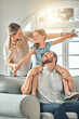 © Clement C/peopleimages.com - Mom, dad and child on sofa with flying game, piggy back and playful fun in living room for happy family. Mother, father and kid playing airplane games on couch with smile, happiness and love in home.