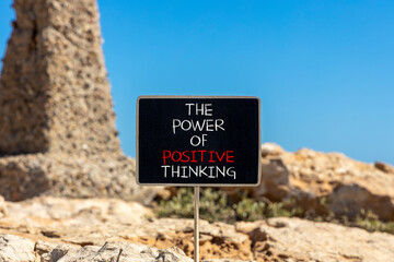 Positive thinking symbol. Concept words The power of positive thinking on beautiful black chalkboard. Beautiful stone blue sky background. Business, motivational positive thinking concept. Copy space.