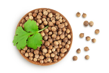 Dried coriander seeds in the wooden bowl with fresh green leaf isolated on white background. Top view. Flat lay