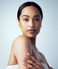 Skincare, makeup and portrait of woman isolated on a white background for skin glow, shine and beauty for luxury. Face of young model or biracial person, natural cosmetics or dermatology in studio