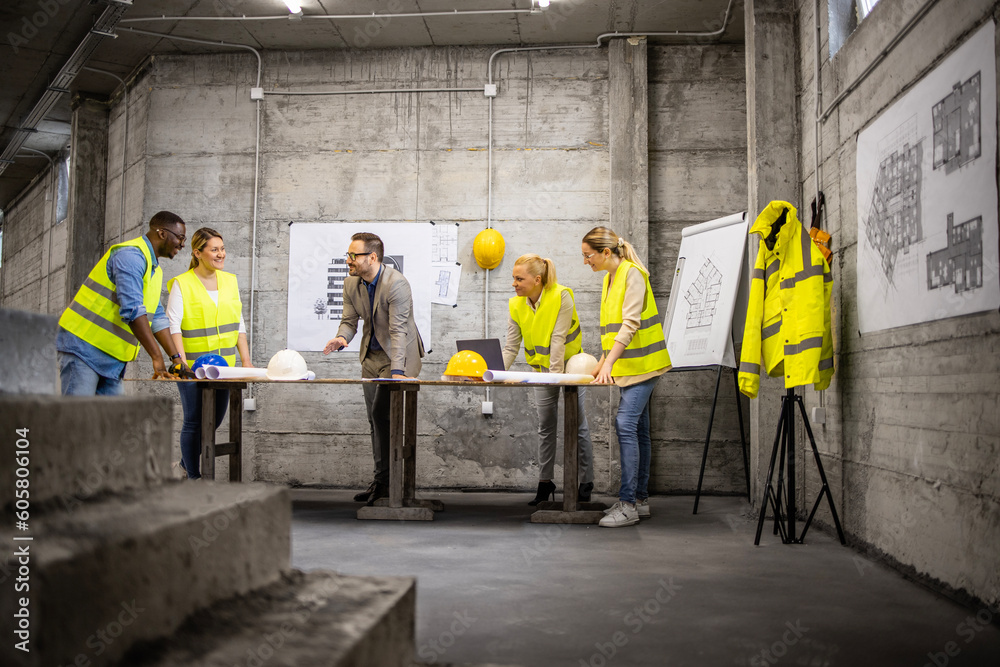 Team of structural engineers and architects analyzing plans and ...