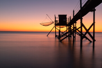 Wall Mural - Fishing hut on stilts coast of Atlantic ocean at sunset near La Rochelle, Charente Maritime, France