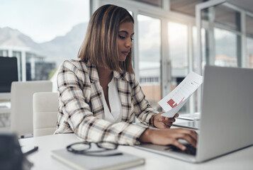 Laptop, business analyst and woman typing documents in office workplace. Paperwork analysis, computer and female person reading, working and analyzing data, graphs or charts for finance statistics.