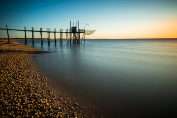 Wall Mural - Fishing hut on stilts coast of Atlantic ocean at sunset near La Rochelle, Charente Maritime, France