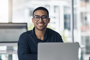 Poster - Portrait, laptop and a professional journalist man at work in an editing agency for news reporting. Computer, smile and online content with a happy male editor working in a modern journalism office