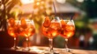 aperol spritz summer drink in glass with tropical background and splash