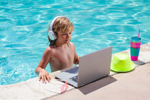 Child Working With Laptop On Summer Vacation Holidays. Little Freelancer Using Computer, Remote Working In Swimming Pool. Summer Online Technology.