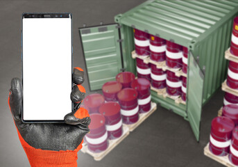Poster - Fuel container. Phone blank screen. Smartphone in man hand. Barrels fuel on pallets. Container for transportation of oil. Website phone template. Copy space on white. Fuel storage and transportation
