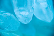 Rock crystal in blue light.transparent quartz crystals background in blue tones.texture of gemstone. crystals of natural transparent stone rock.Texture of natural stone Rock crystal