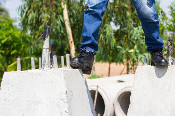 Wall Mural - Wear safety shoes to ensure safety at work. construction workers wear safety shoes. People with factory safety concept