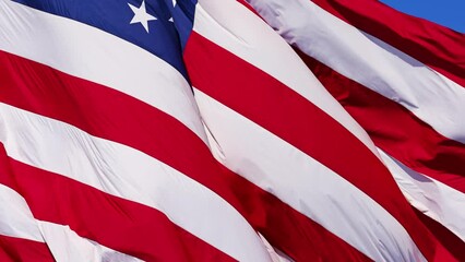 Wall Mural - close up of the us flag blowing in the breeze.