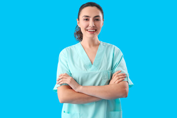 Wall Mural - Female medical assistant on light blue background