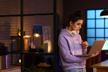 Poster - Young female programmer with laptop in office