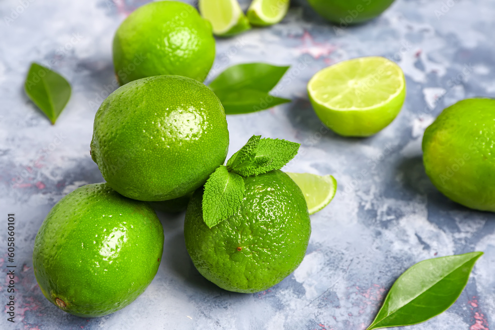 Fresh limes with leaves on blue background