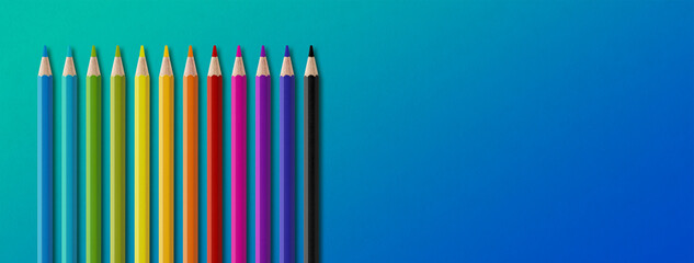 Poster - Colored pencil group isolated on blue. Panoramic banner background