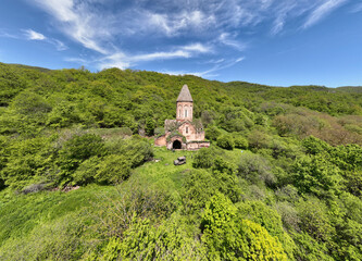 Wall Mural - the ancient church hid in the forest in the gorge of the mountains of Armenia taken from a drone