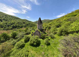 Wall Mural - the ancient church hid in the forest in the gorge of the mountains of Armenia taken from a drone