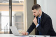 © เลิศลักษณ์ ทิพชัย - Portrait of handsome young salesman using laptop looking at contract or agreement Buy or sell a new car Salesman signs car insurance documents or lease agreement documents.