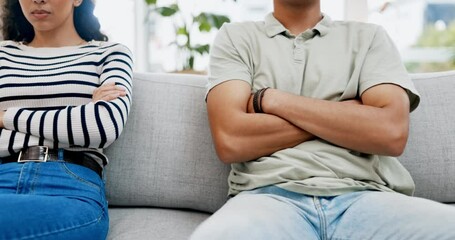 Wall Mural - Couple, separation and conflict on sofa from disagreement fight or argument with arms crossed at home. Upset man and woman sitting on couch in frustration or angry for unhappy relationship or problem