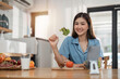 © Natee Meepian - Beautiful Asian woman in kitchen at home. Health care concept. relaxation concept