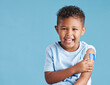 © Siphosethu F/peopleimages.com - Portrait, happy and kid with plaster in studio isolated on a blue background mockup space. Face, smile and boy child with bandage after vaccine, injury or wound for healthcare, first aid and excited.